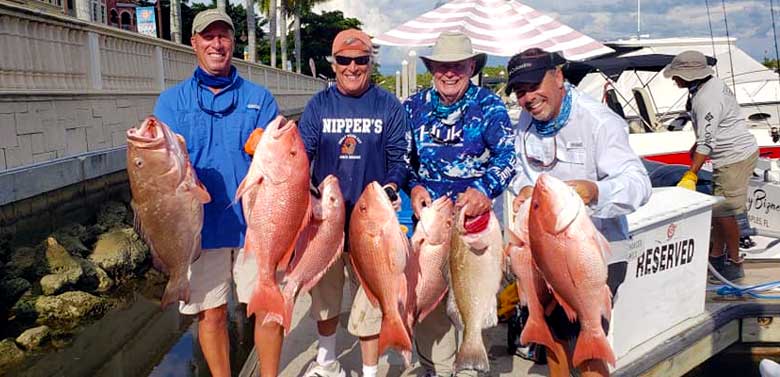 Men Holding Red Snapper | FishyBizness Fishing Charters & Boat Tours in Naples, Florida
